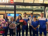 Akrobatika gimnastikası üzrə Dünya çempionatının medalçıları vətənə qayıdıblar (FOTO)